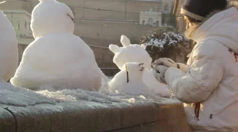 Child making a snowman Stock Footage 10772875