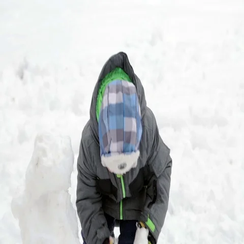Child Making a Snowman in Winter Stock Footage 69510577