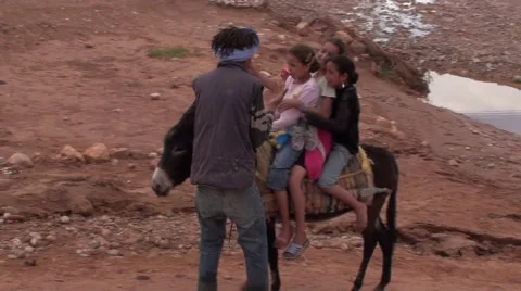 Child making a stroll on a Donkey in Morocco Stock Footage 52924549