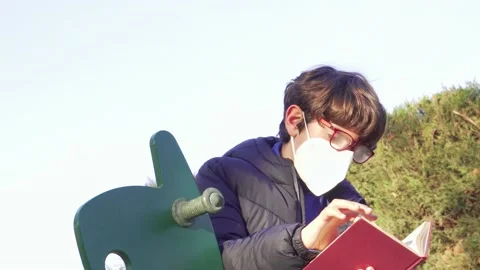 Child with mask reading Stock Footage 171288738