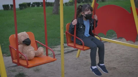 Child in mask on a swing. Stock Footage 143880796