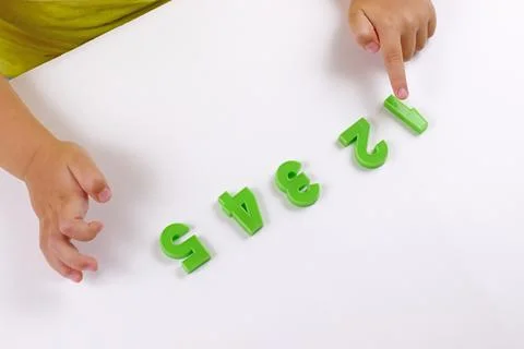 Child math development, learning center, sorting skills concept. Child's hands Stock Photos