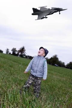 Child on meadows with fighter Stock Photos
