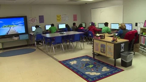 Child migrants using computers in at Texas family residential immigration center Stock Footage 114555850