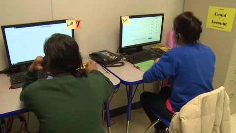 Child migrants using computers at Texas family residential immigration center Stock Footage 114555861