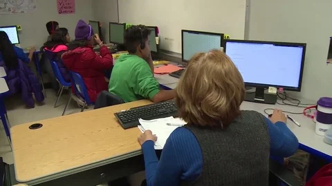 Child migrants using computers at Texas family residential immigration center Stock Footage 114555863