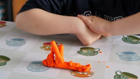 Child Modeling Orange Clay Video stock 75155482