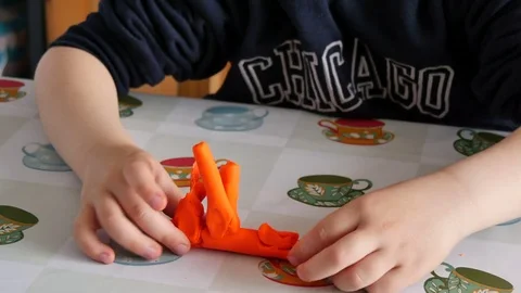 Child Modeling Orange Clay Stock Footage 80510876