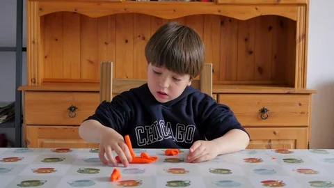 Child Modeling Orange Clay Stock Footage
