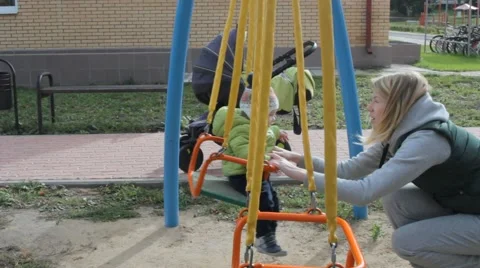 Child with mom on the playground Stockbeeldmateriaal 59864450