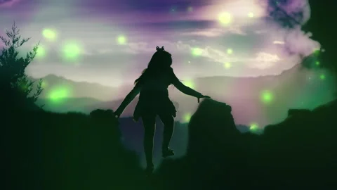 A child on a mountain observes colored particles Stock Footage 141110499