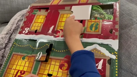 Child opening up DAY 10 of the Advent Calendar leading up to Christmas. Stock Footage 145239737