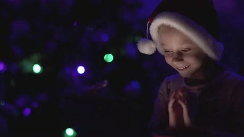 Child opens a glowing gift Stock Footage 145534996