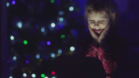 Child opens a glowing gift Stock Footage 146367664