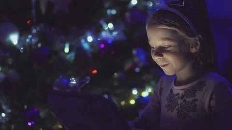 Child opens a glowing gift Stock Footage 146368009
