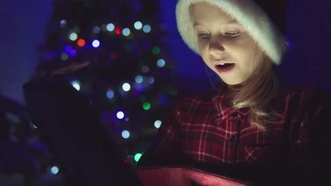 Child opens a glowing gift Stock Footage 146368301
