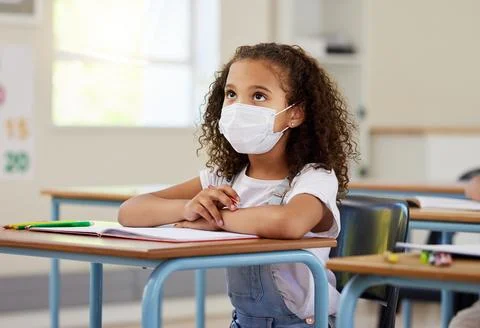 Child or student in class during covid, wearing a mask for hygiene and 스톡 사진