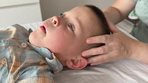 Child Osteopathy Therapy Side View Hands on Ears Video stock 320949015