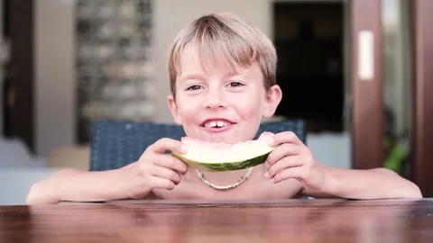 Child outdoor eating a refreshing slice of watermelon  Stock Footage 136814636