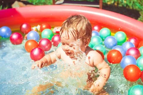 The child in the outdoor pool Stock Photos