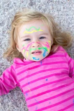 Child with paint on face Stock Photos