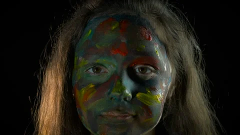 Child painted makeup against black background Stock Footage 326100412