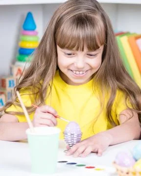 Child painting Easter eggs Stock Photos
