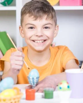 Child painting Easter eggs Stock Photos