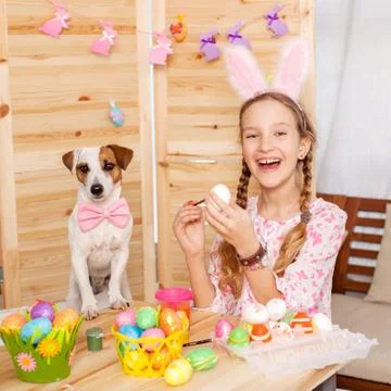 Child painting Easter eggs Stock Photos