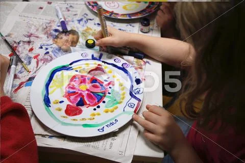 A Child Painting On A Plate
