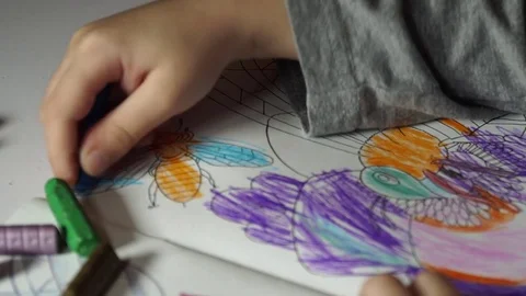 Child paints coloring with crayons Stock Footage 82490746