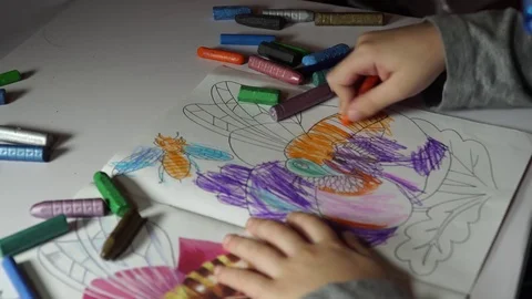 Child paints coloring with crayons Stock Footage 82490807