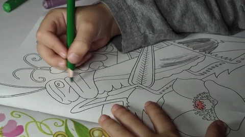 Child paints coloring with crayons Stock Footage 82490994