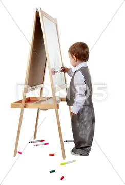 A child paints on an easel in the studio Stock Photos