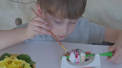 Child paints Easter eggs. Happy easter Stock Footage 149755817