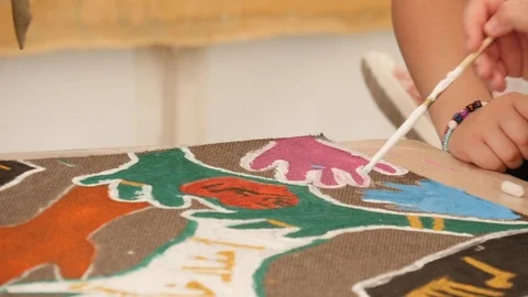 A child paints a hand with a thin brush Stock Footage 112003682