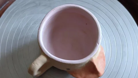 Child paints on rotating clay cup on the pottery wheel. Creativity. Stock Footage 291629873