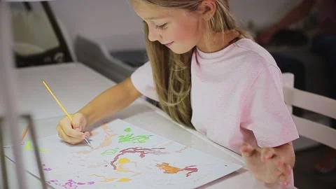 Child paints at the table Stock Footage 166166477