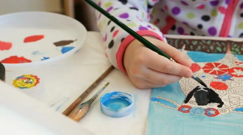 Child paints watercolor picture with paint brush Stock Footage 59741759