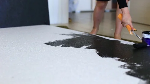 The child paints white polystyrene with black paint Stock Footage 129834997