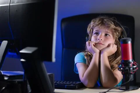 Child with pc computer at night. School, study, online learning concept. Overuse 스톡 사진