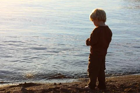 Child peeing on beach Stock Photos
