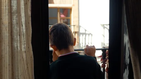 The child peeps on the balcony Stock Footage 86890746