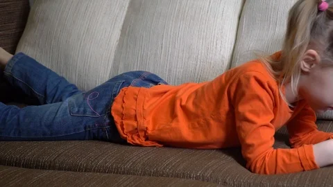 Child with a phone on the couch Stock Footage 126407289