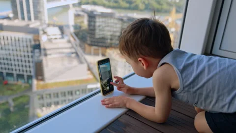 Child with phone exploring city. Stock Footage 313924250