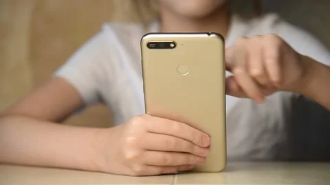 A child with a phone in his hands. Stock Footage 145084874