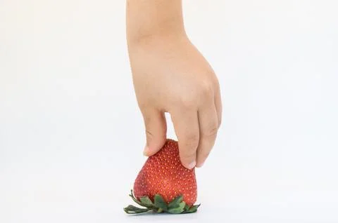 Child picking a strawberry Stock Photos