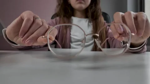 Child placing glasses on table, eyewear for reading, preparing to study Stock Footage 328420826