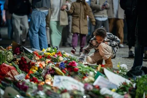 Child Placing Tea Light at Makeshift Memorial Place for Deceased Alexei Navalny Stock Photos