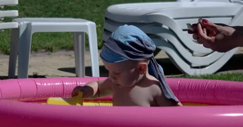 Child Play and Having Fun in Inflatable Pool on Green Lawn in a Sunny Day 스톡 동영상 65781058